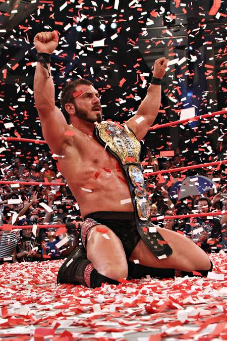Daniel Healy celebrating a championship victory in the ring